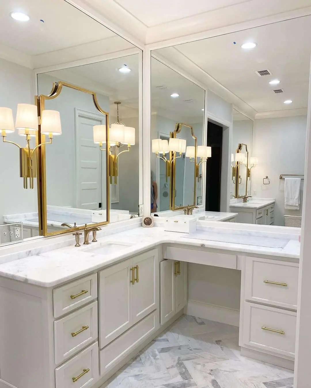 Ornate Gold Mirrors Create Grandeur Above a Marble Vanity