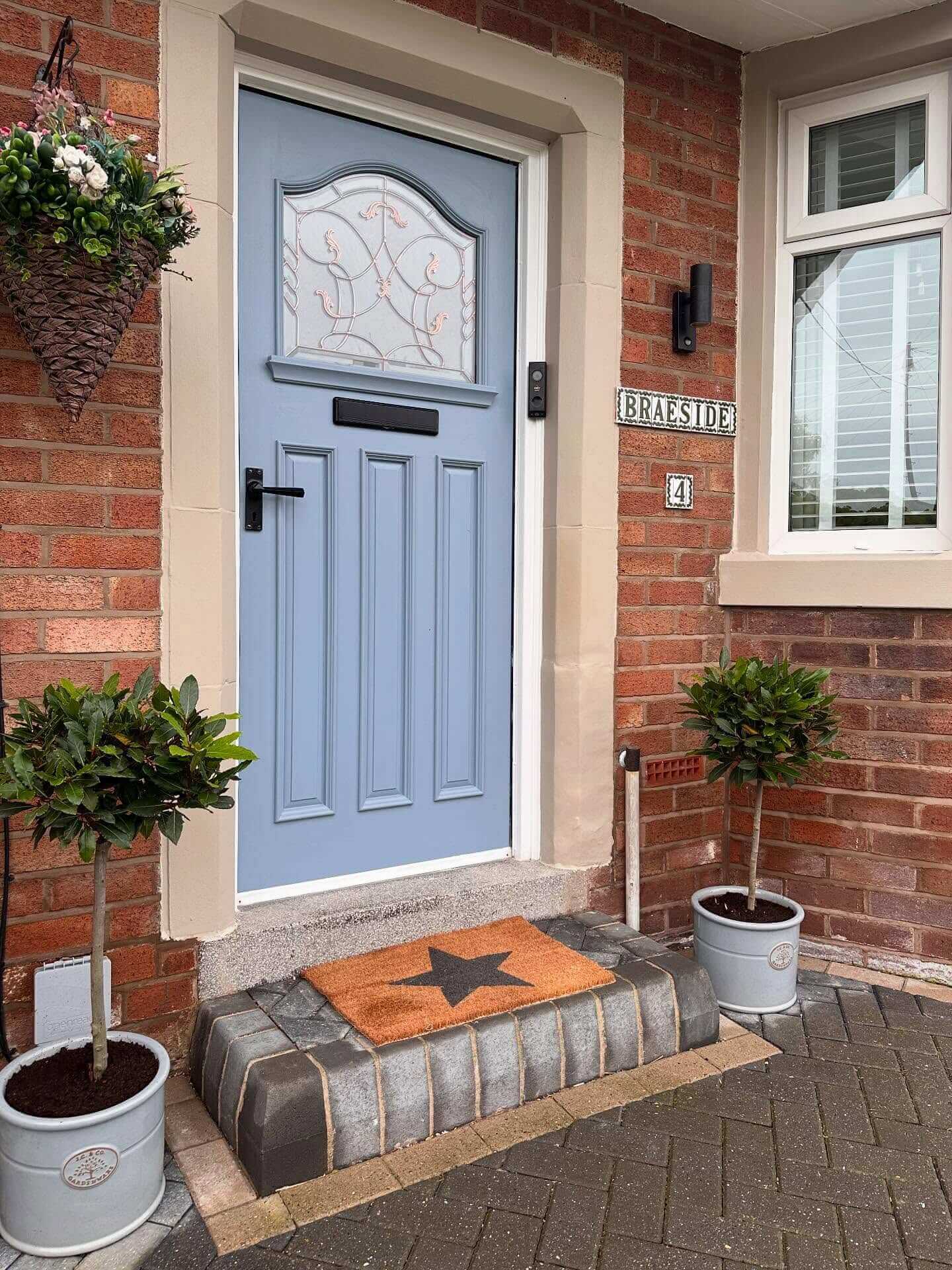 Blue Door With A Star-Embossed Coir Doormat