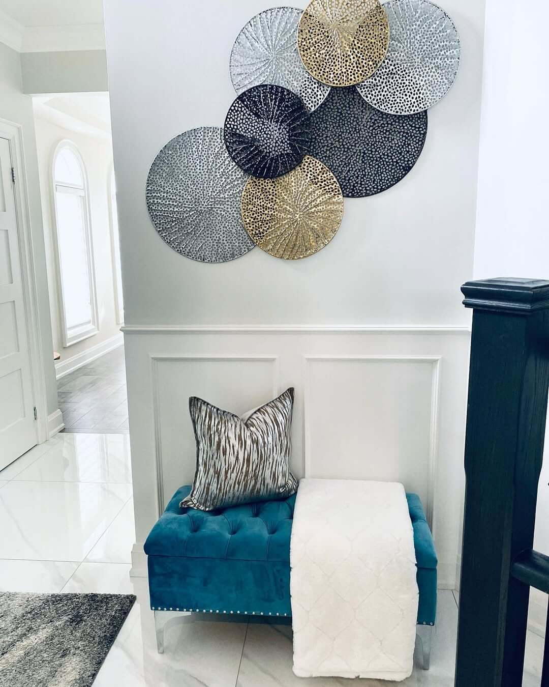 Round Metal Wall Art Adds Textured Shine Above Entryway Bench