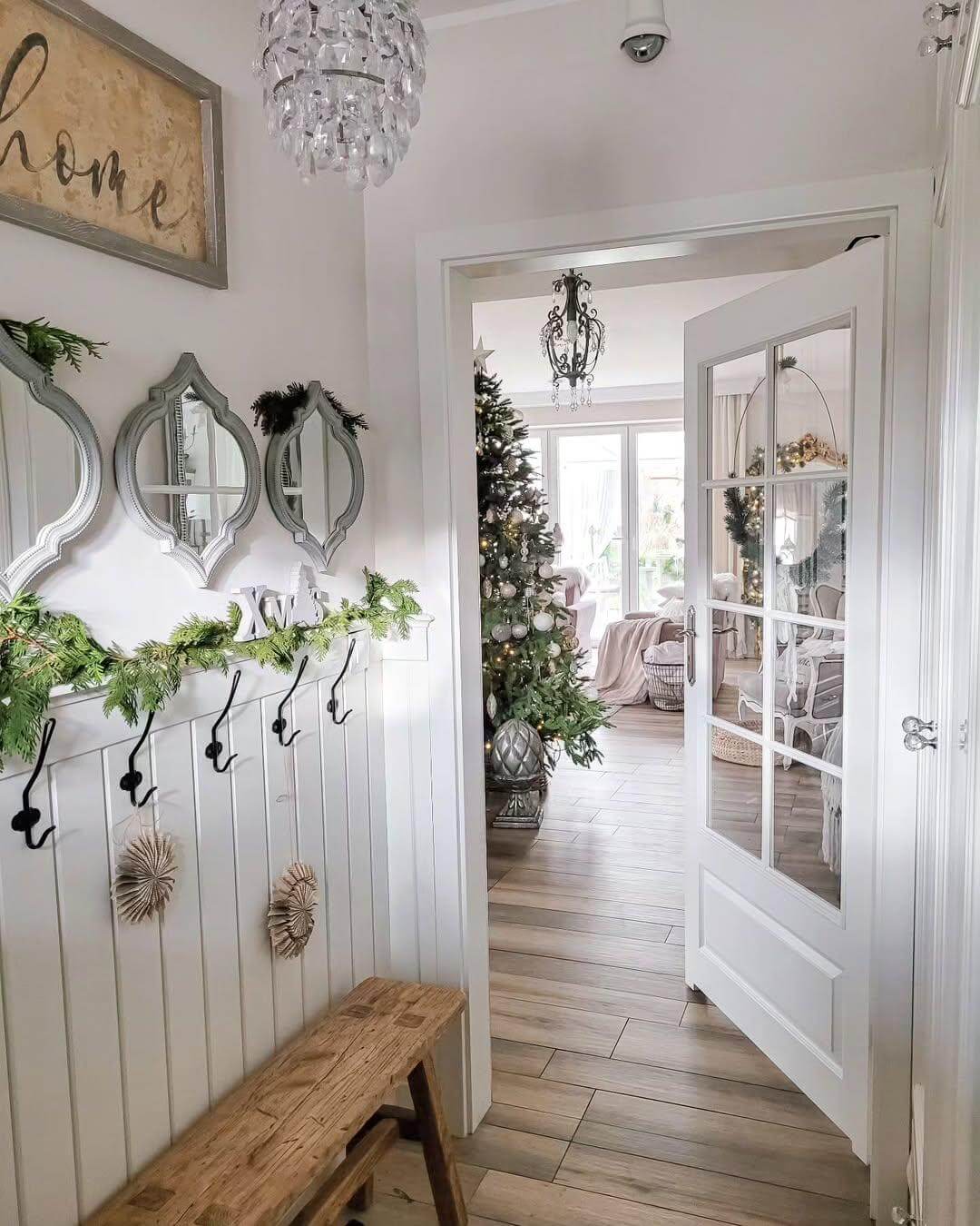 Mirrored Wall Sconces Add Glamour Above Entryway Hooks