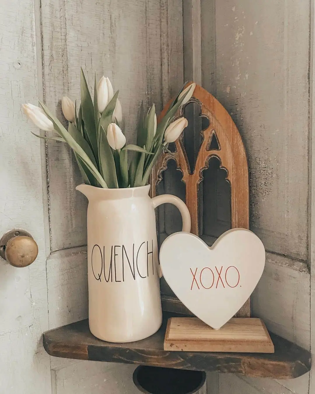 Cream Pitcher Vase With 'QUENCH' Text Holds White Tulips