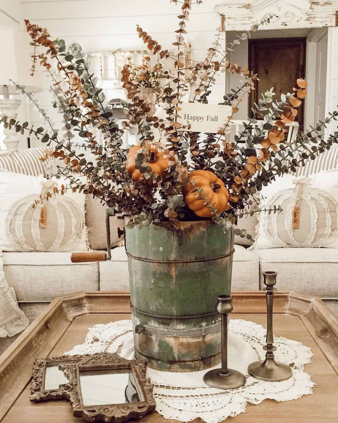 Distressed Green Ice Cream Maker Holds Autumnal Stems