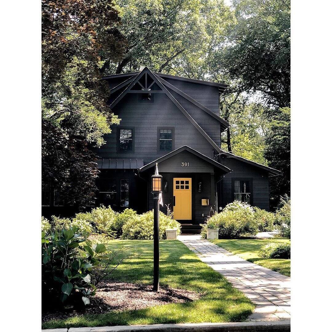 Bright Yellow Door Pops Against Dark Exterior