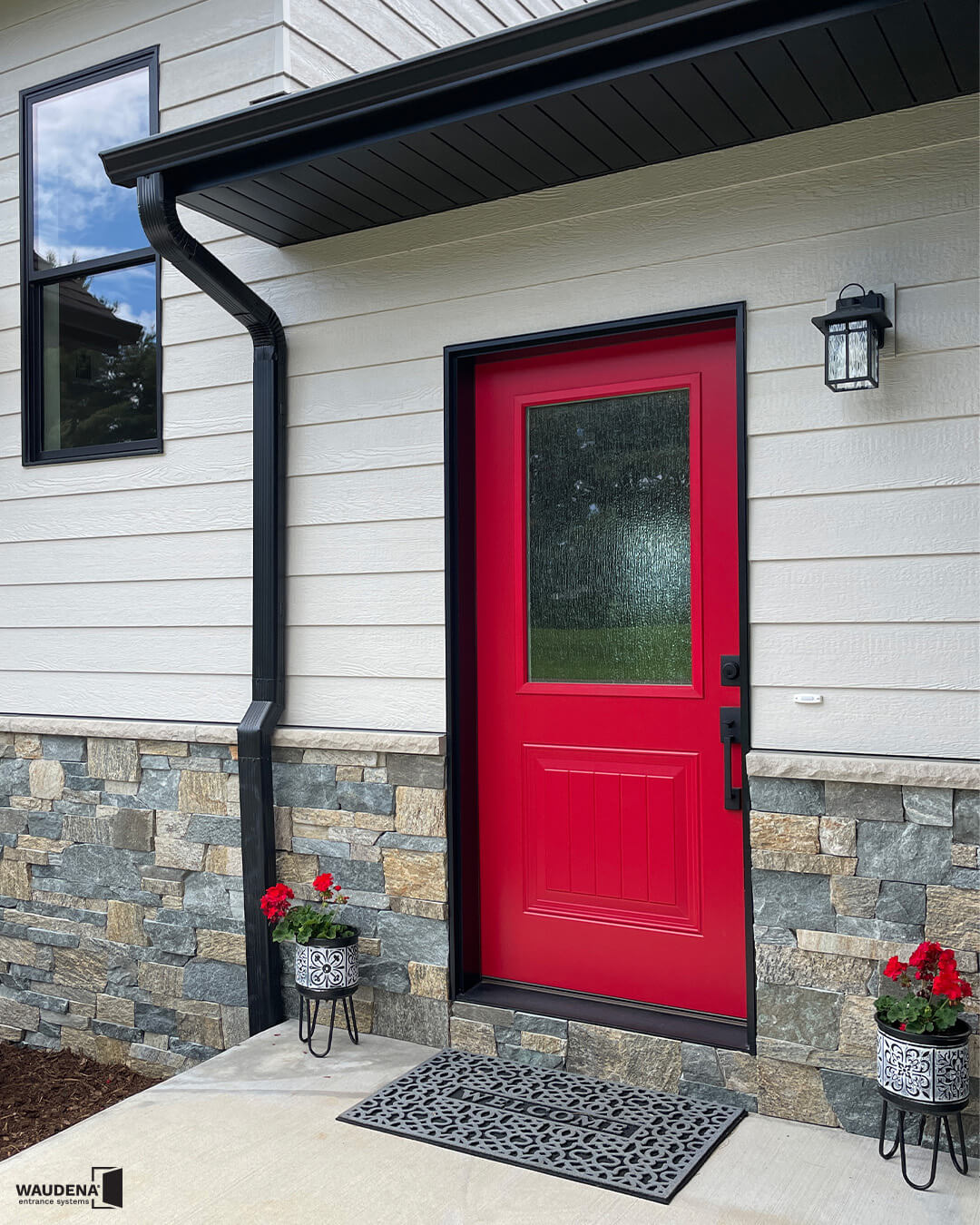 Bold Red Door With Black Accents and Matching Planters