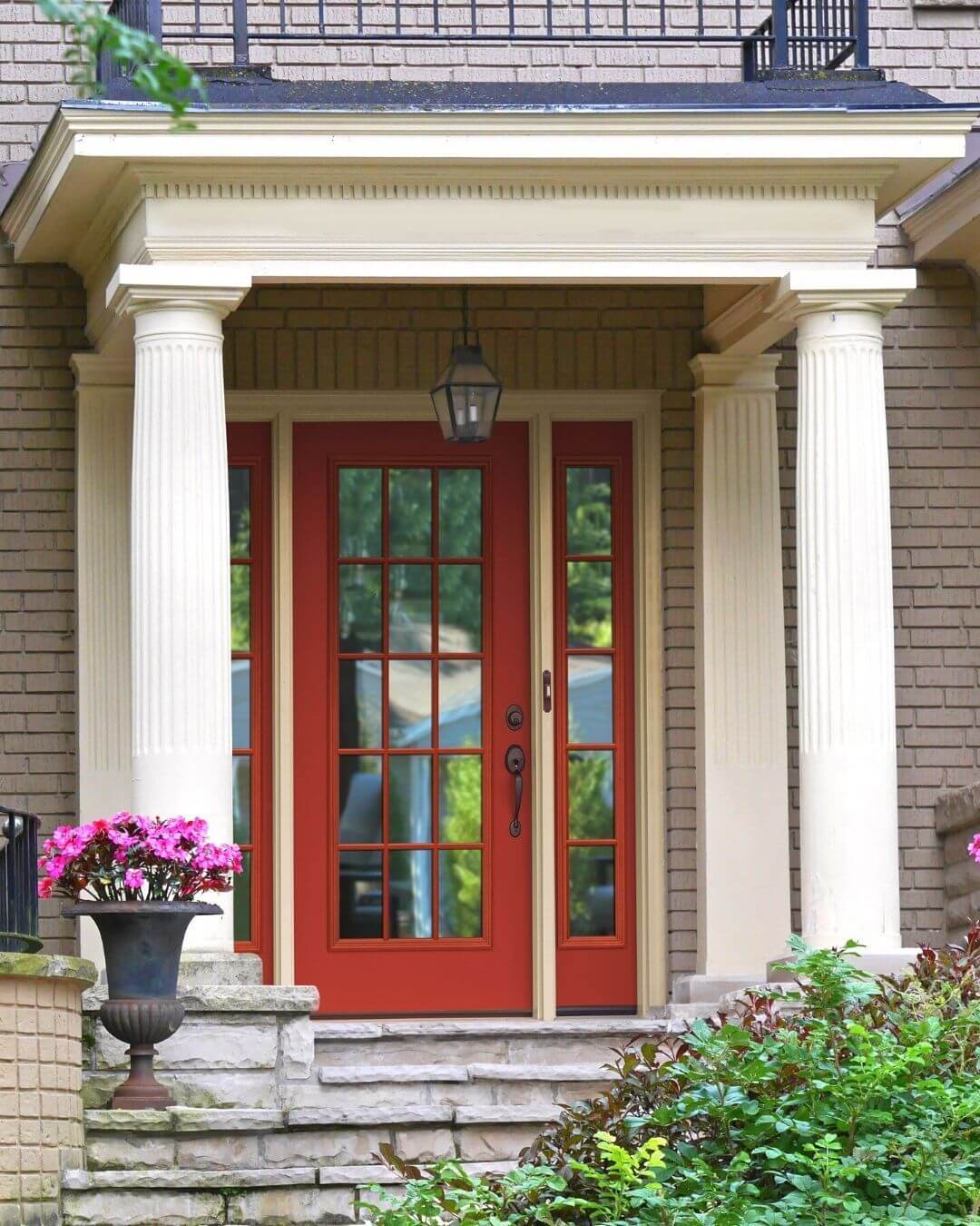 Bold Red Door With Classic Columns and Urn Planter