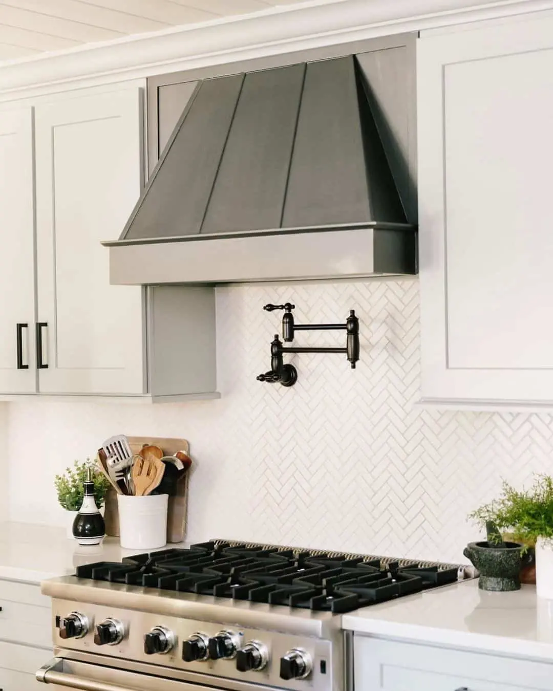 Dark Metal Range Hood With Paneled Design
