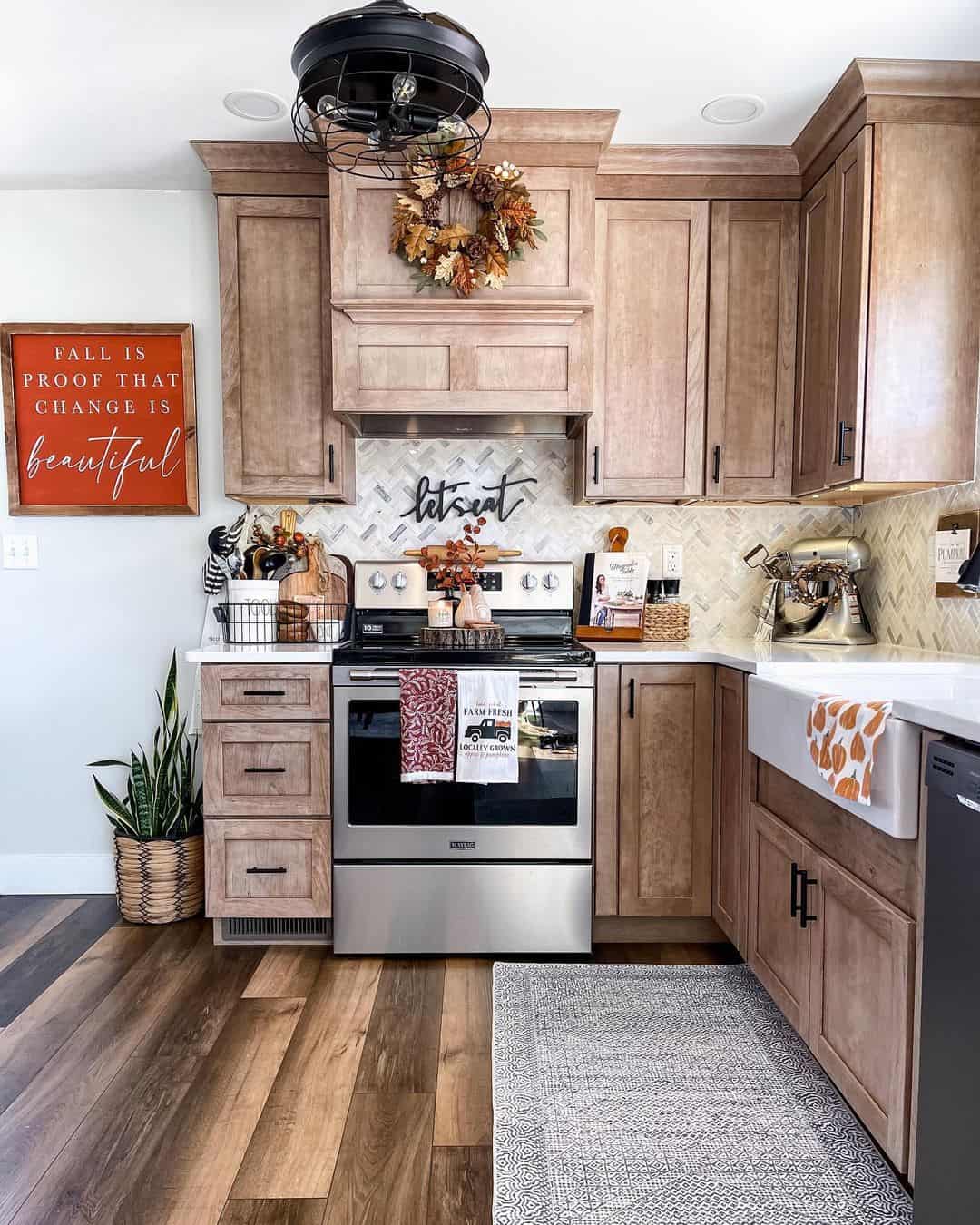 Wood cabinetry frames a subtle herringbone backsplash