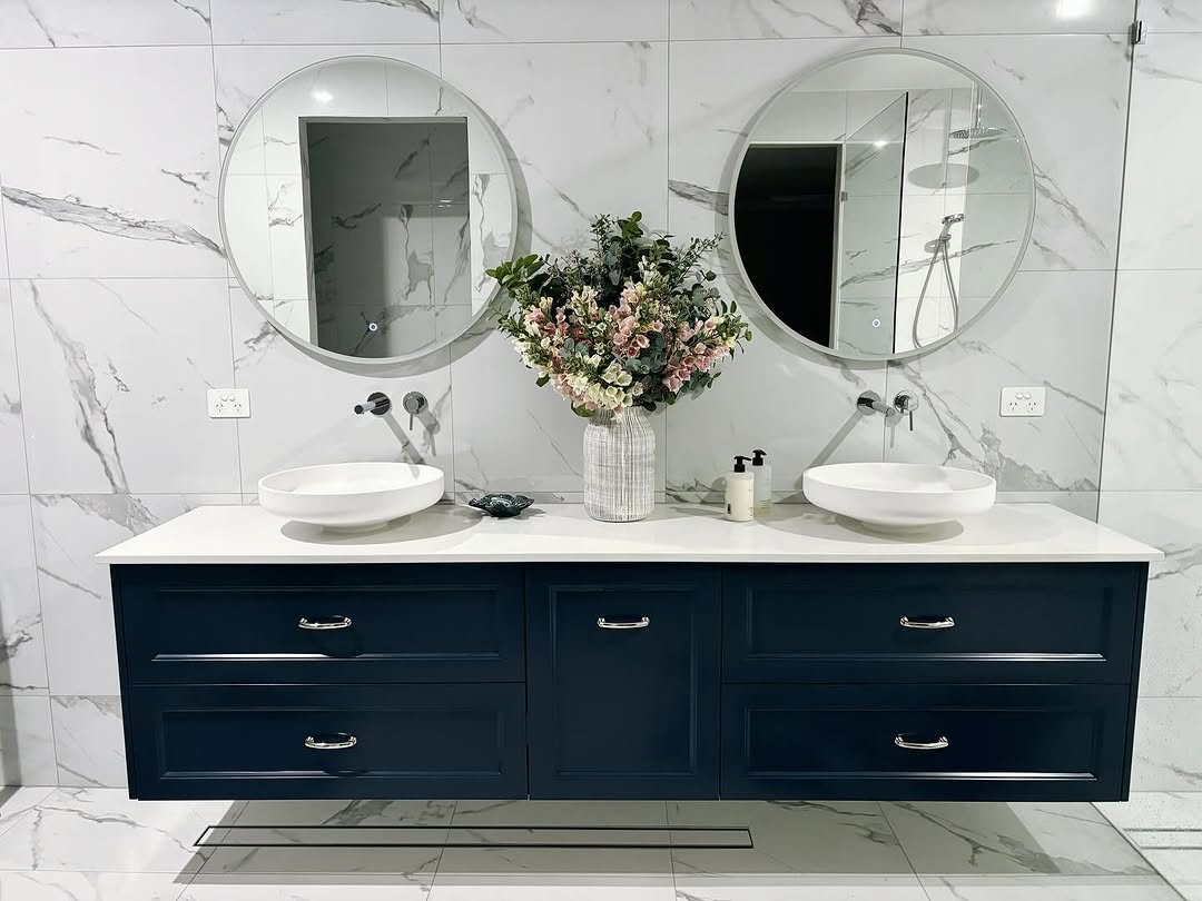 Floating Navy Vanity With White Vessel Sinks