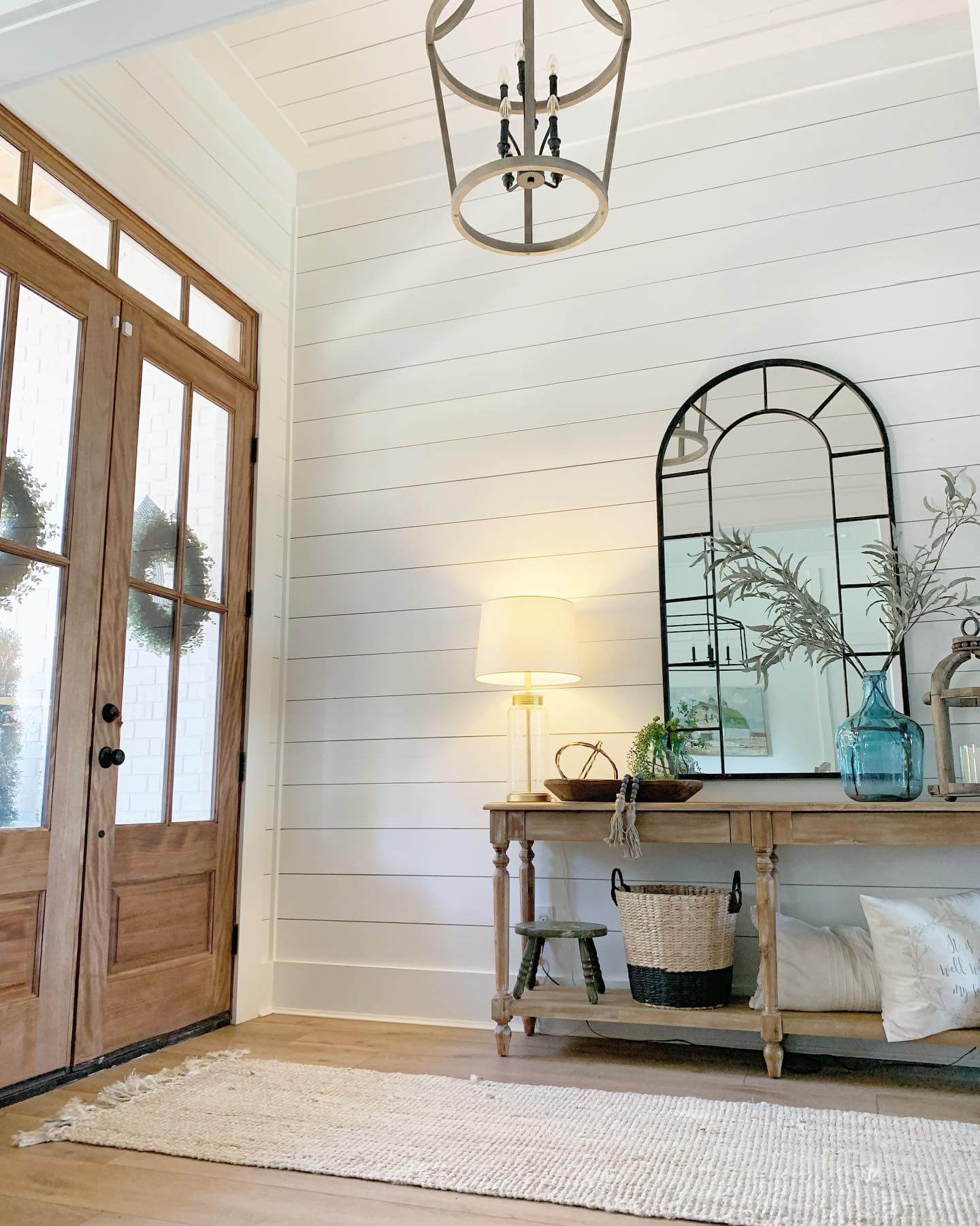 Arched Windowpane Mirror Reflects Entryway Light