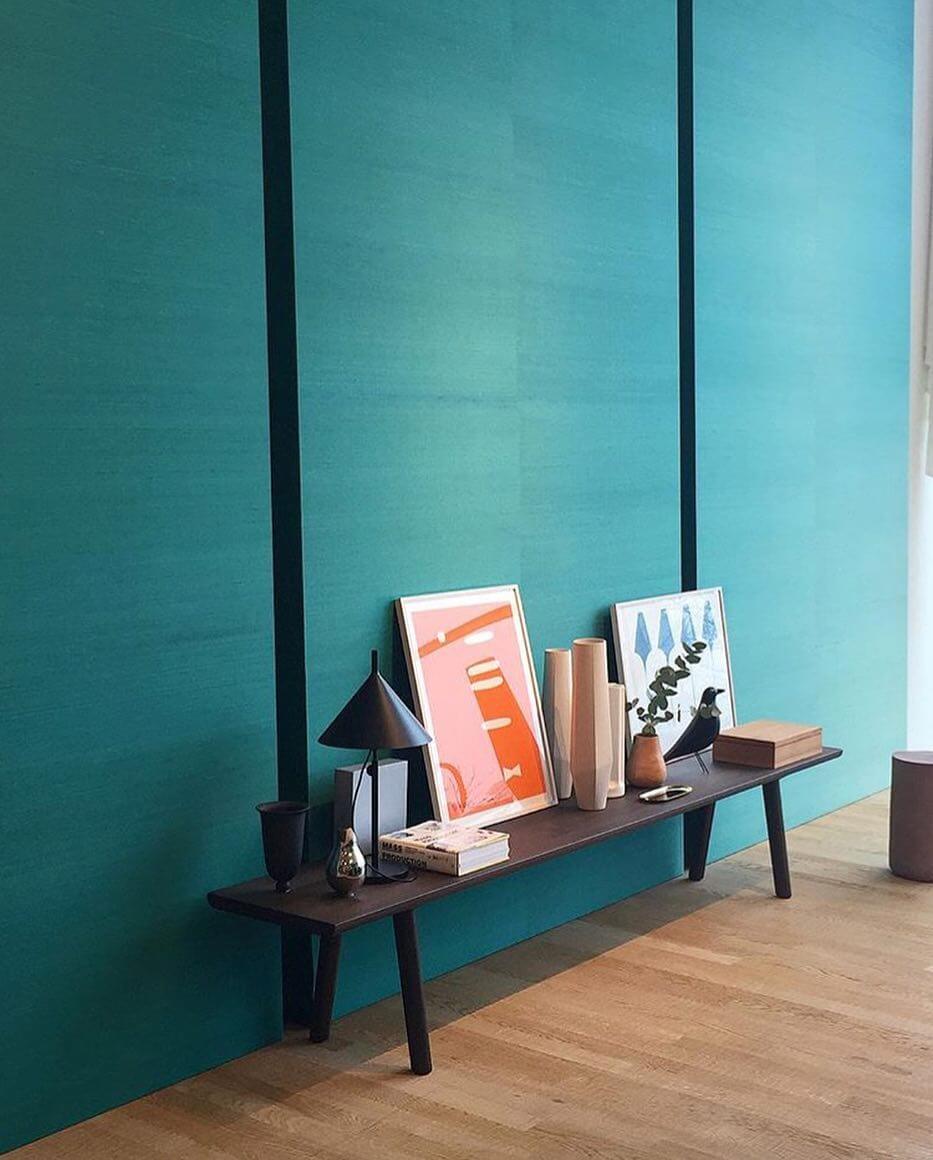 Teal Walls Frame a Dark Wood Bench Display