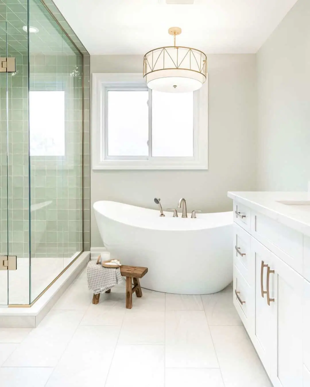 Freestanding Tub With a Natural Wood Stool for Soaps