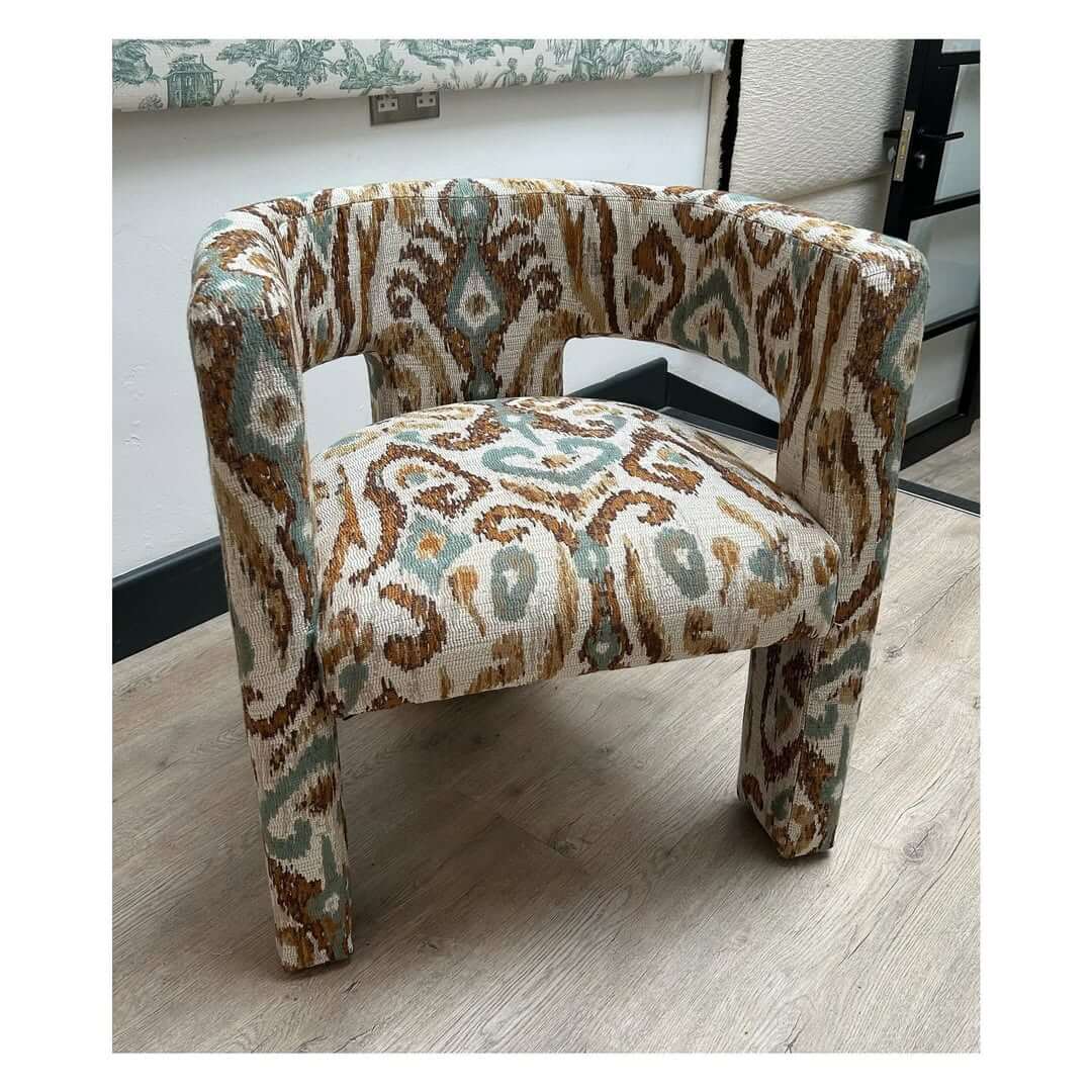 Ikat Upholstery Makes a Curved Chair a Bold Focal Point