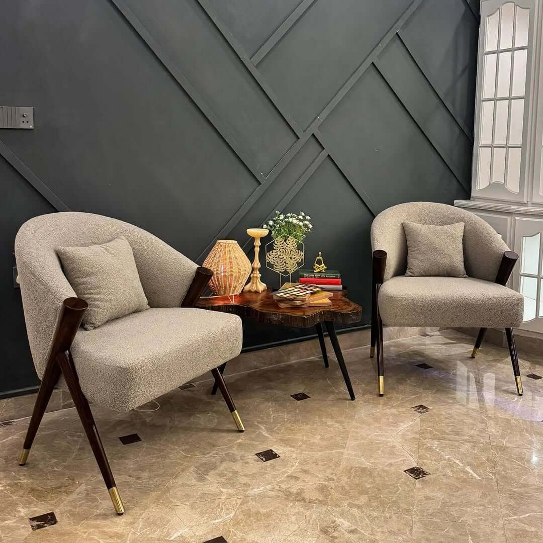 Curved Bouclé Chairs Flanking a Live-Edge Table