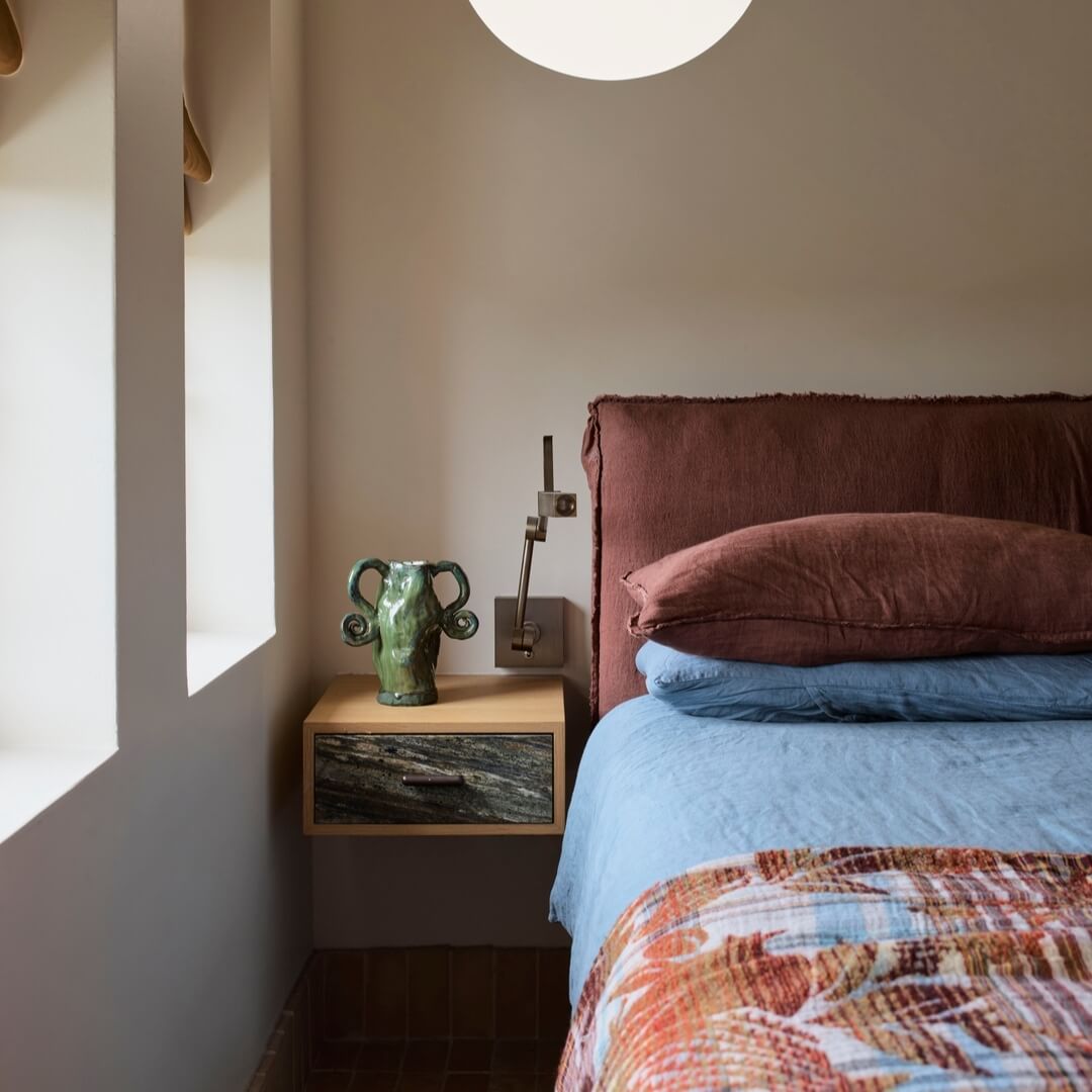 Marble-Fronted Drawer Adds a Moody Accent to a Light Wood Nightstand