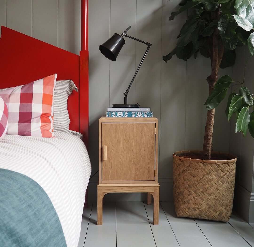 Light Oak Cabinet With Minimalist Lamp and Patterned Books