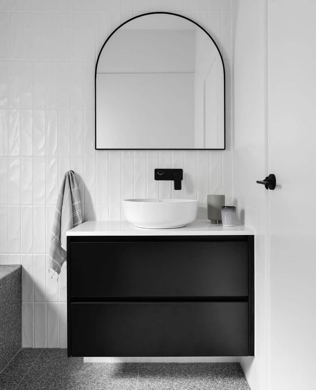Soften White Tiles with an Arched Black Mirror
