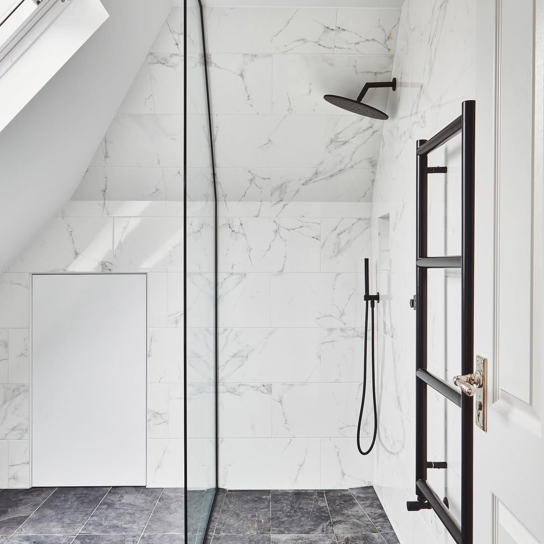 Matte Black Heated Towel Rail Next to a White Door