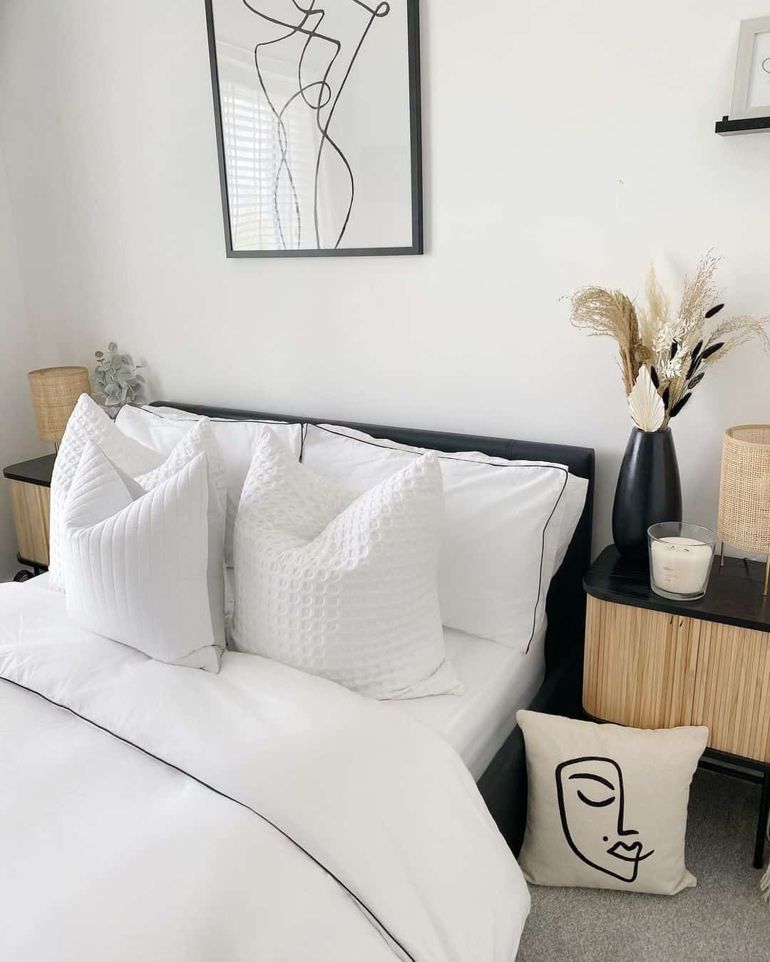 Abstract Face Pillow Adds Graphic Art Above a Black Headboard