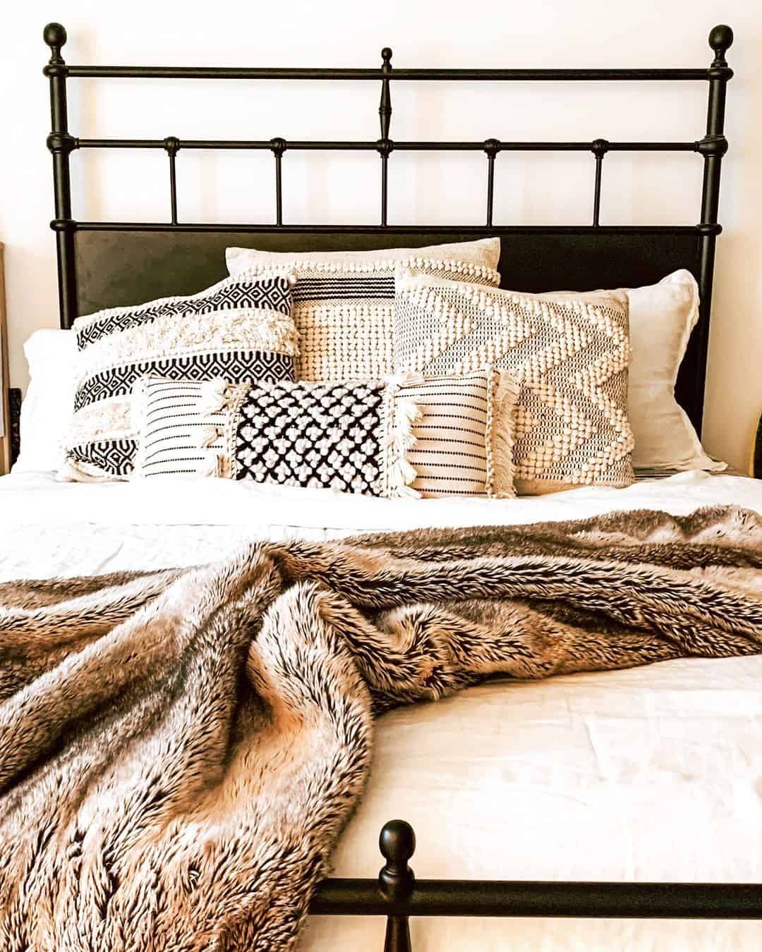Layered Black and White Pillows Add Boho Texture to Bed