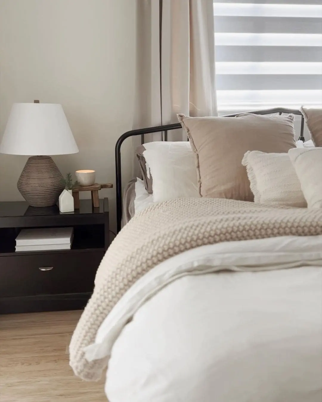 Soften a Black Metal Frame with Neutral Pillows