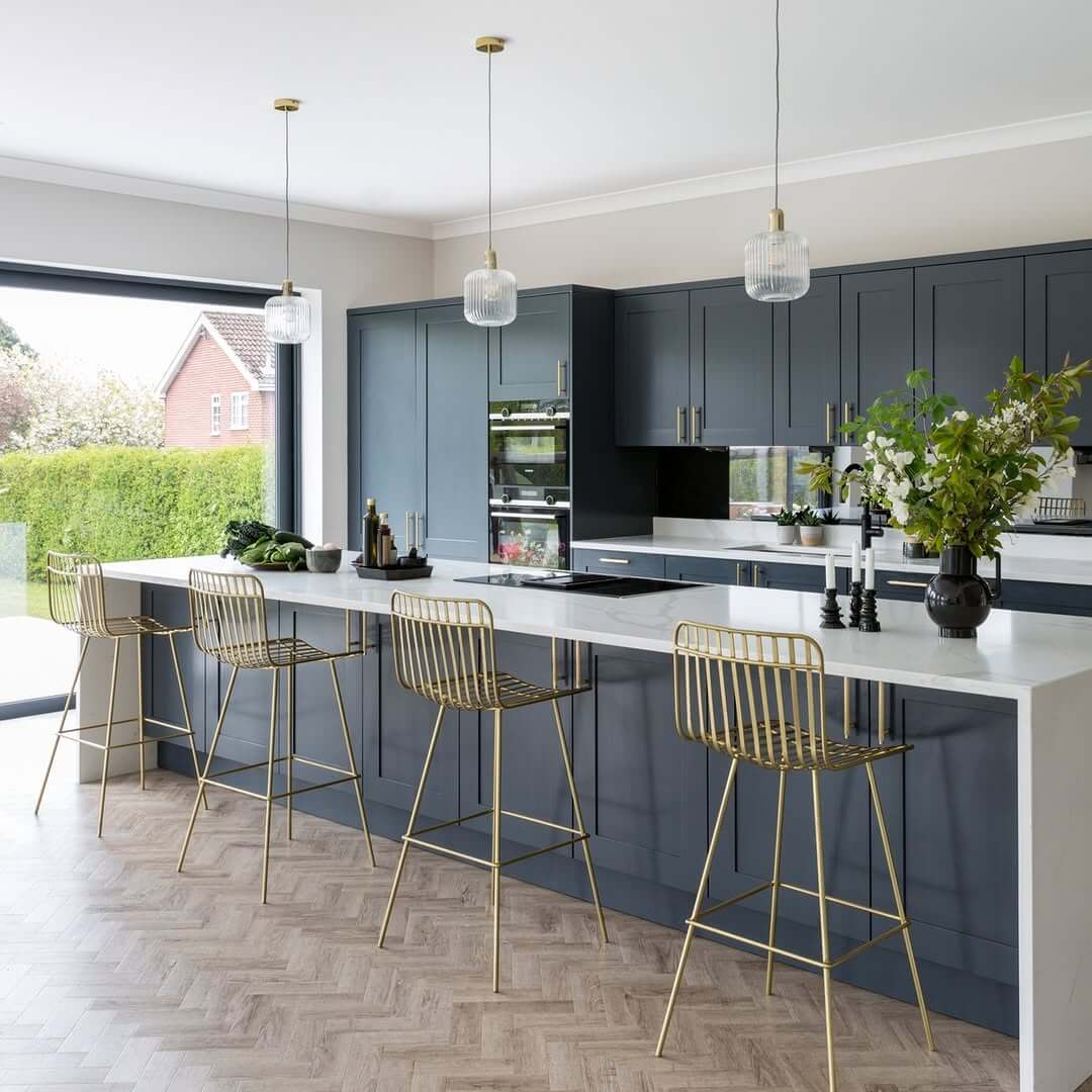 Gold Wireframe Stools Add Glamour to a Deep Blue Island