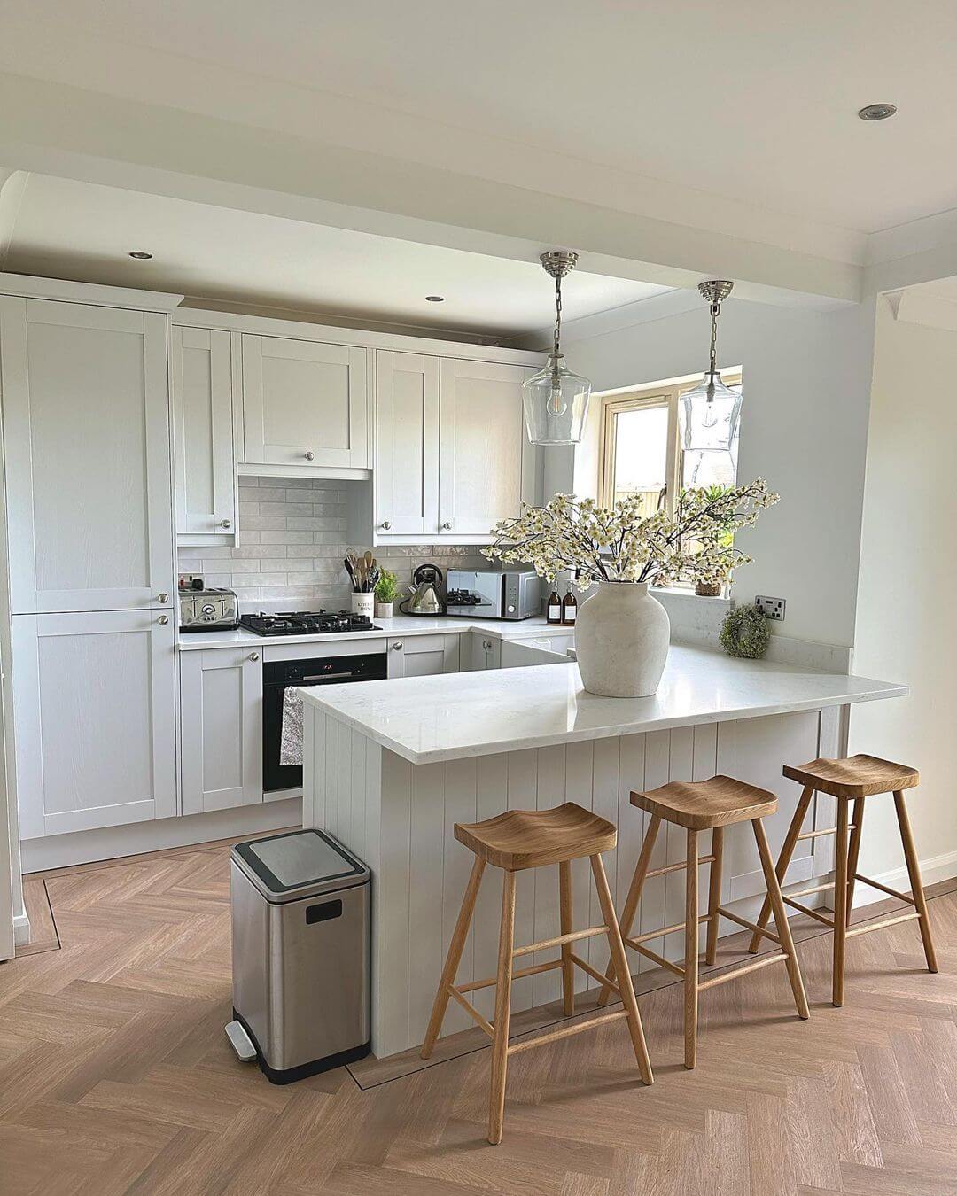 Curved Wooden Stools Complement a Waterfall Island