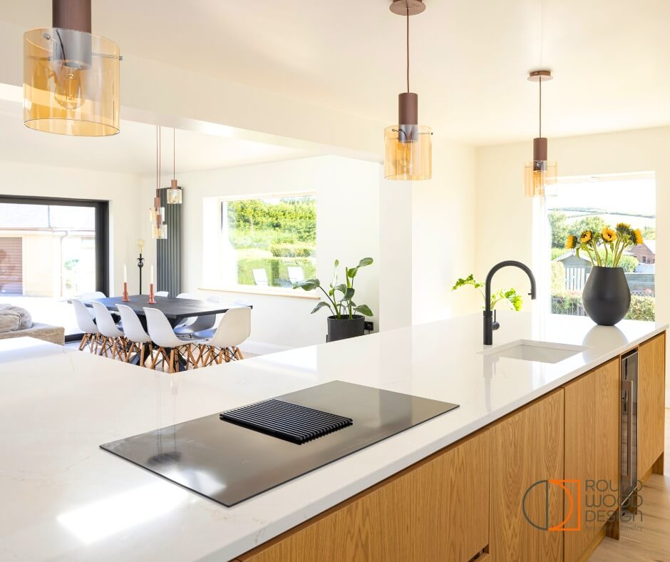 Warm Oak Cabinetry Grounds a Sleek White Breakfast Bar