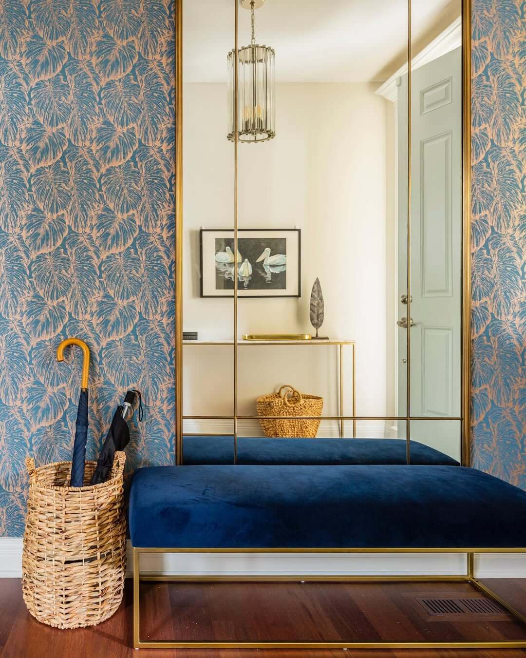 Tall Mirrored Panels Create a Spacious Entryway Feel