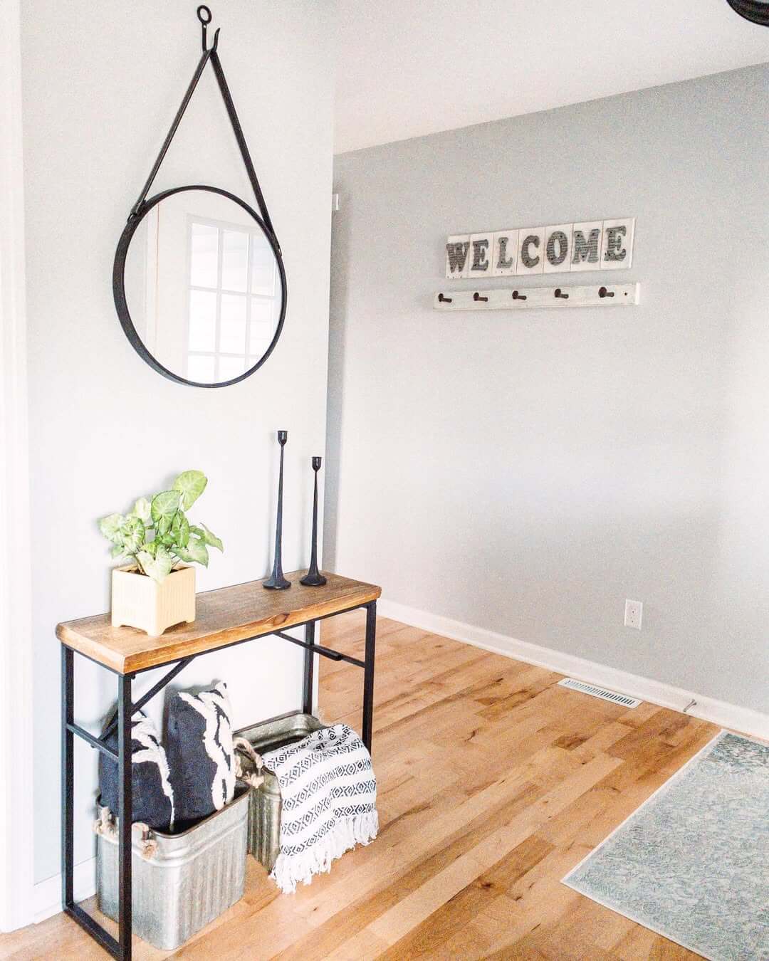 Round Mirror Hung on Leather Strap for a Minimalist Statement
