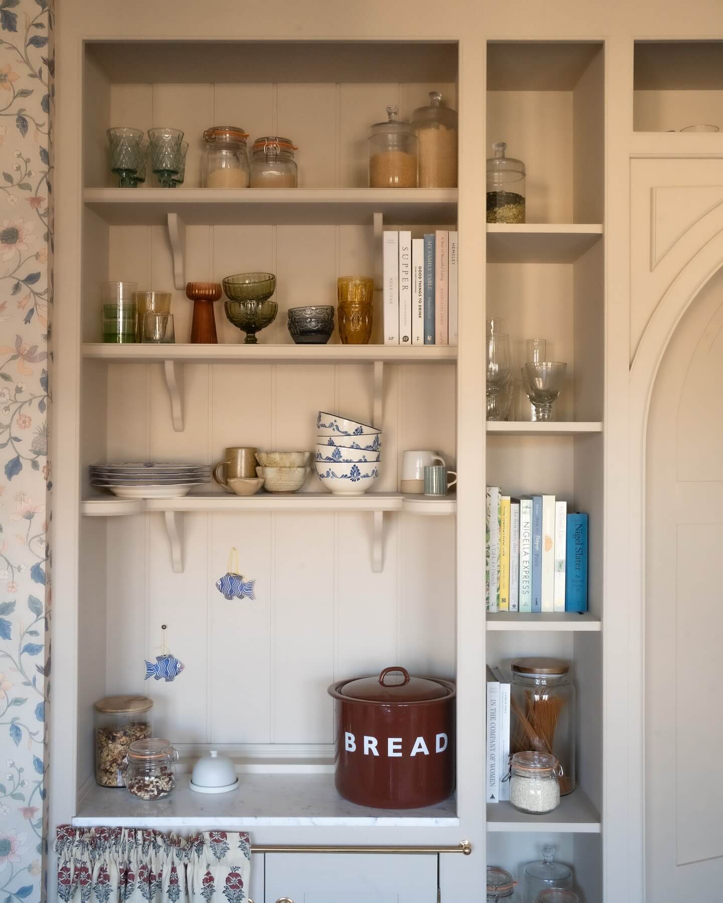 Glassware in varied hues adds a playful touch to open shelving