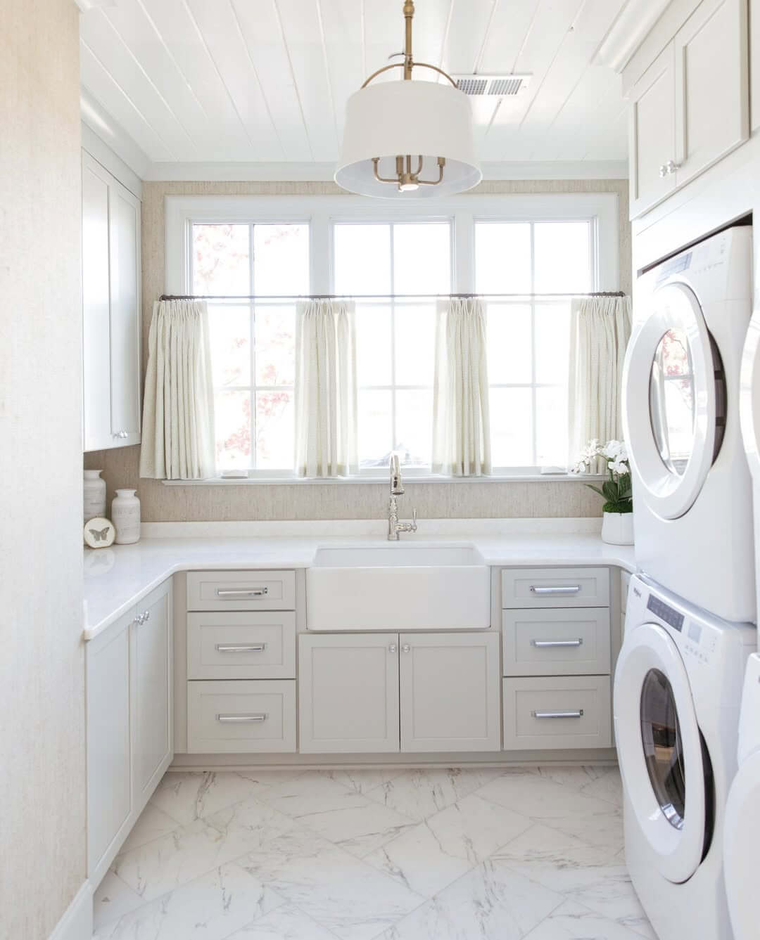 Light Gray Cabinets With Silver Bar Pulls Offer Subtle Storage