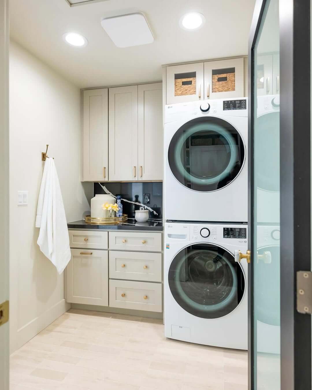 Glass-Fronted Upper Cabinets for Visible Laundry Storage