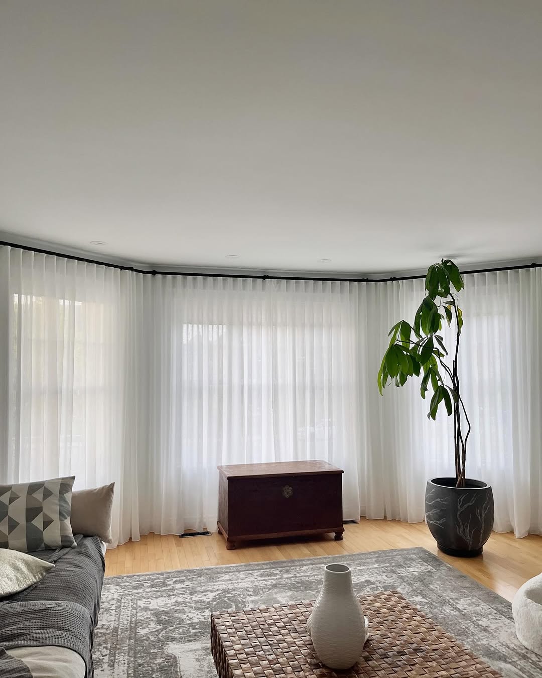 Sheer White Drapes Soften a Bay Window's Light