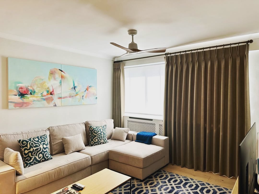 Dark Pinch-Pleat Drapes Add a Rich, Grounded Feel