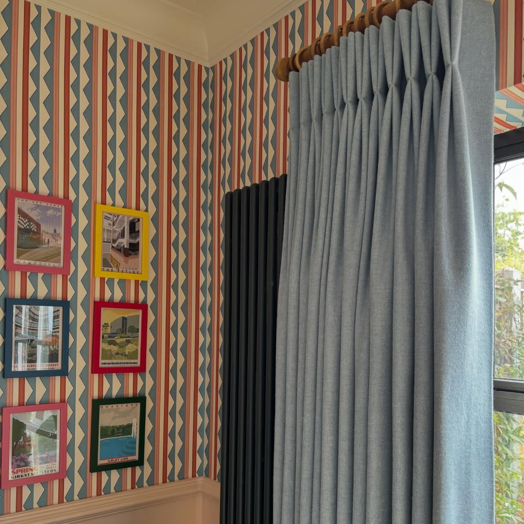 Soft Blue Pleated Drapes Frame a Window With Natural Light