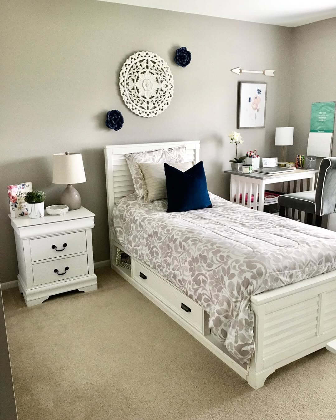 Round Wood Art Anchors a Trio of Navy Floral Accents
