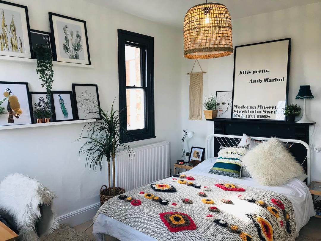 Gallery Wall of Framed Art and Hanging Plants Creates a Layered Look