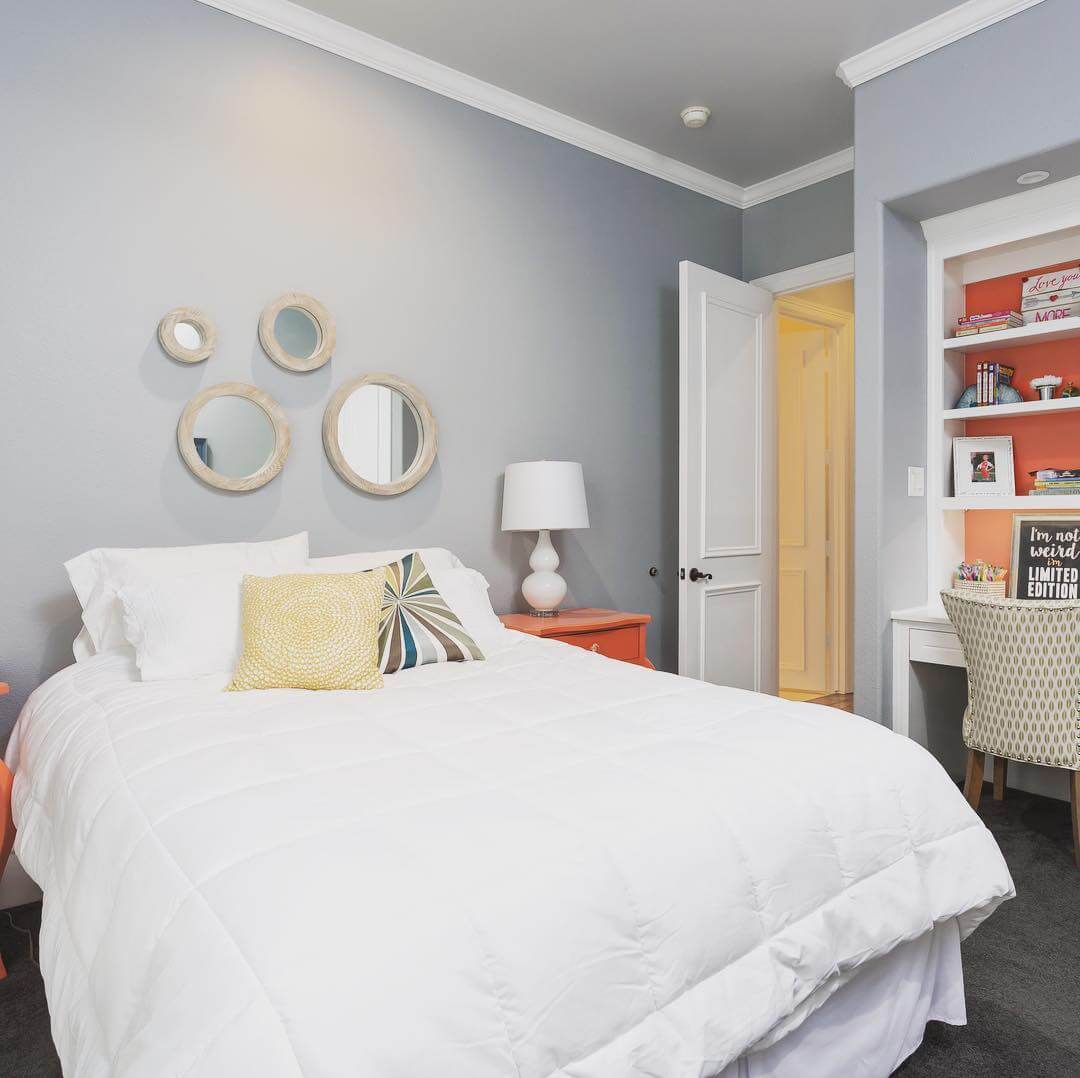 Cluster of Round Mirrors Adds Dimension Above the Bed