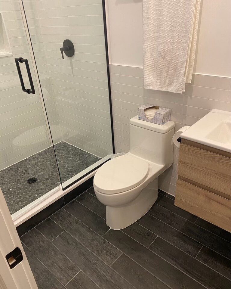 Ground a Small Bathroom with Dark Wood-Look Floor Tiles