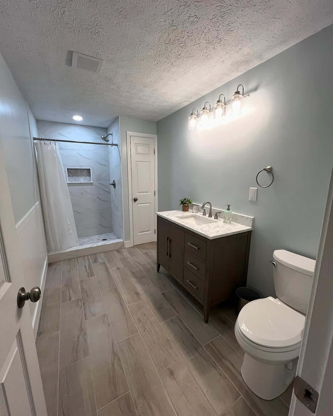 Warm Up Your Basement Bathroom with Wood-Look Floor Tiles