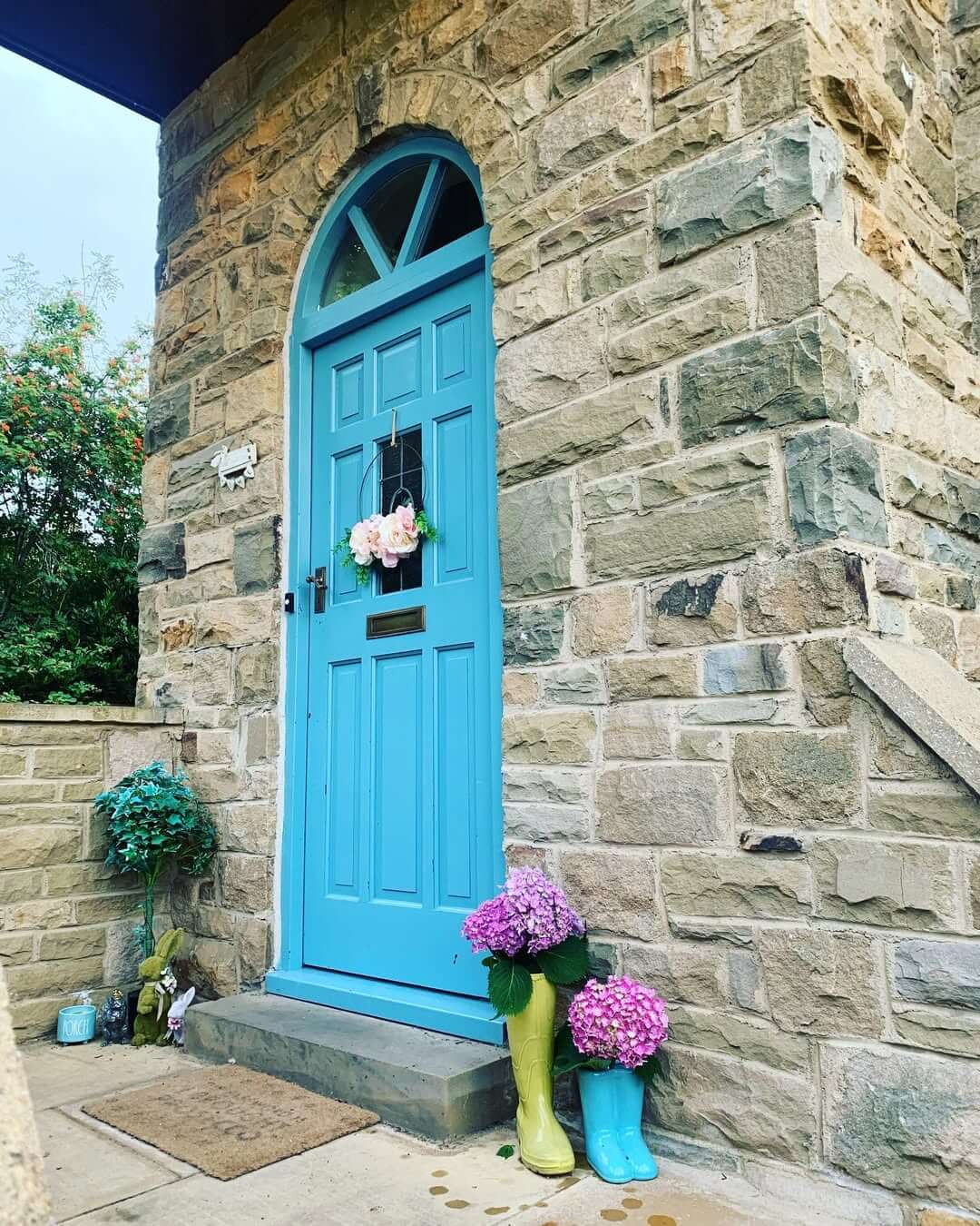 Brightly Colored Rain Boots Hold Hydrangeas For A Cheerful Entry