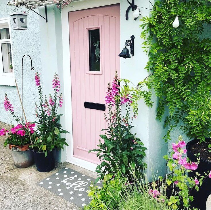 Tall Foxgloves Add Vertical Color To A Pastel Porch