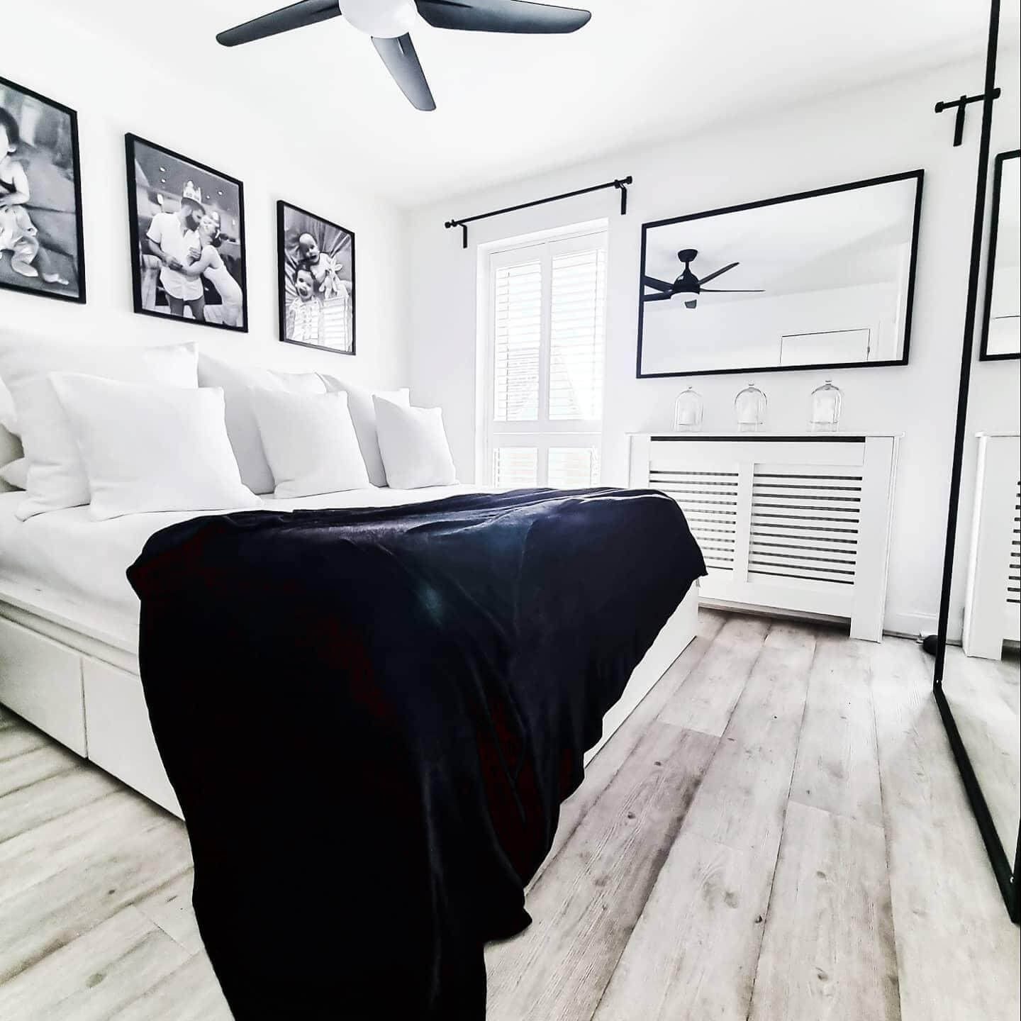 Black and White Photos Add Personal Touch Above Bed