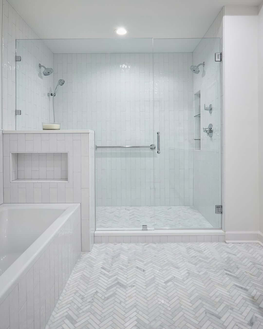 Herringbone Marble Floor Adds Pattern to White Bathroom