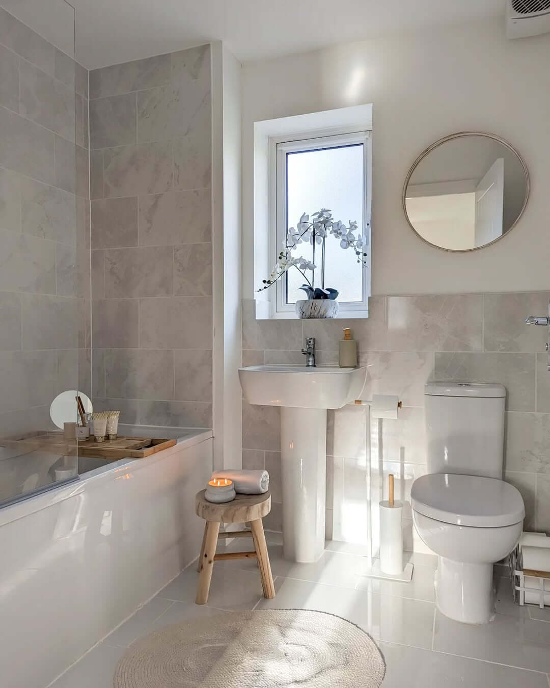 Wooden Stool Adds Natural Texture Next to the Tub