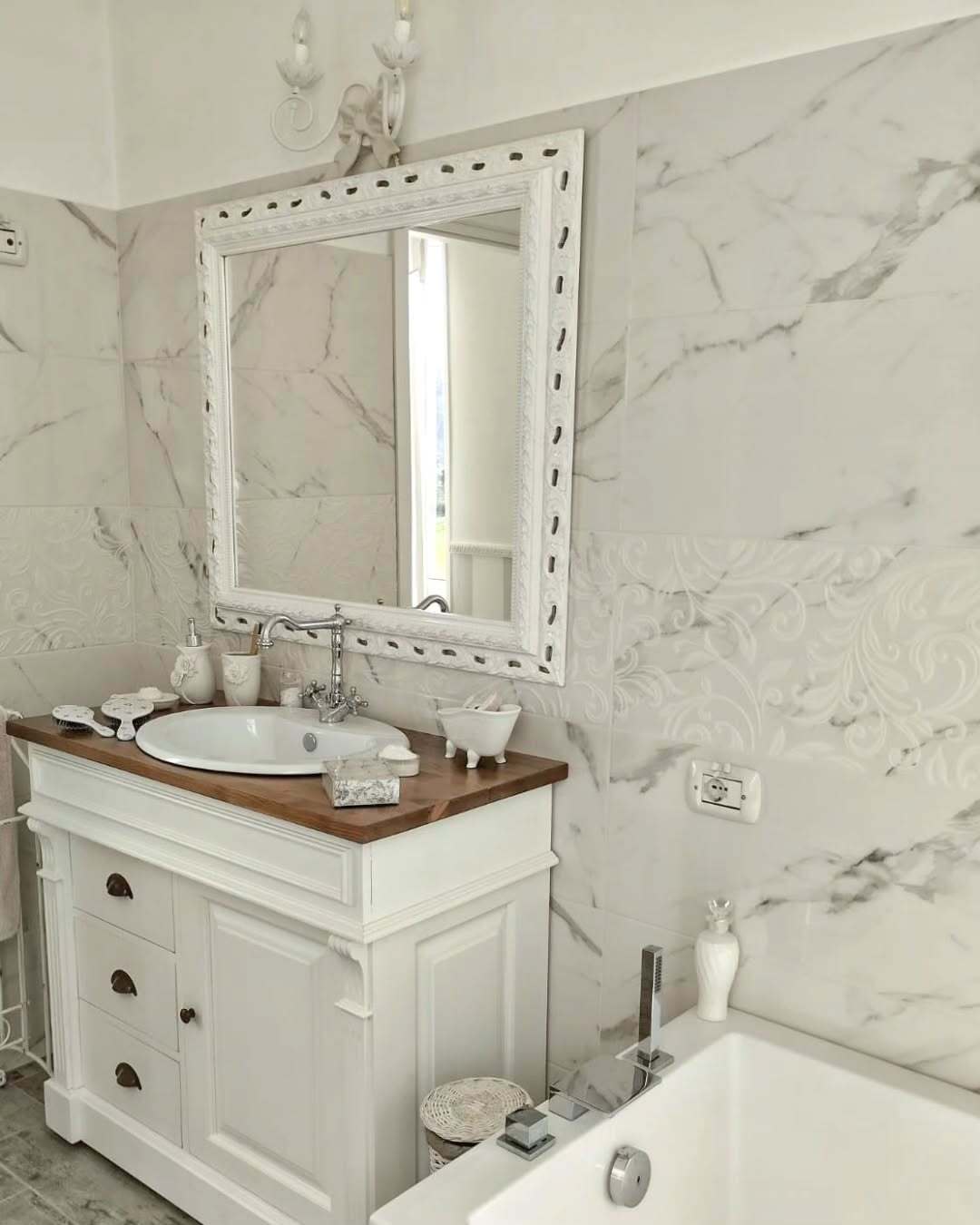 Ornate White Mirror Frames a Marble Vanity Space