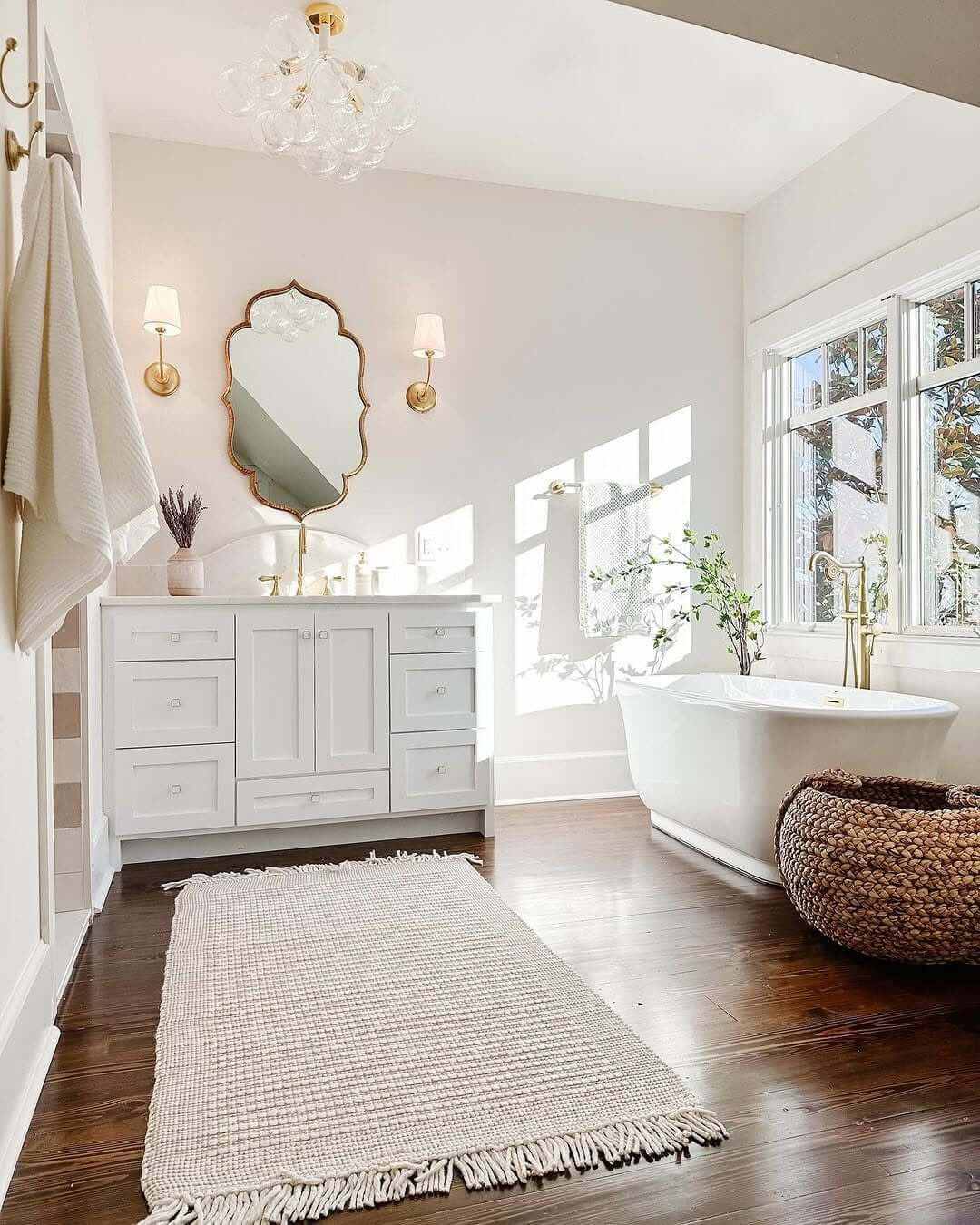 Scalloped Gold Mirror Frames a White Vanity