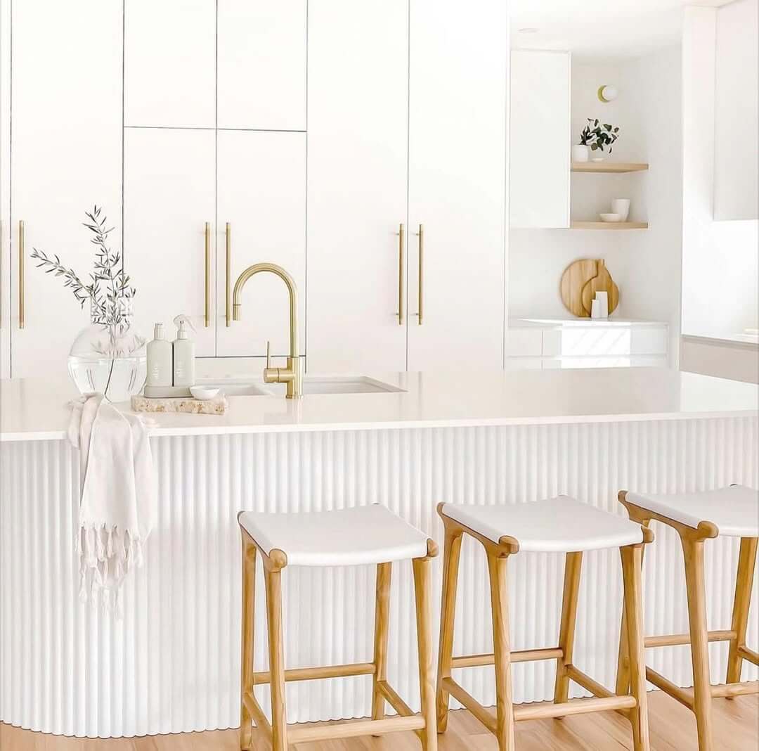 Fluted Island Facade Adds Soft Texture to White Kitchen