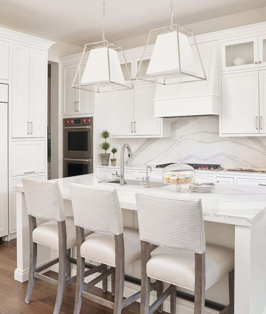 Geometric Pendant Lights Frame the Kitchen's White Hood