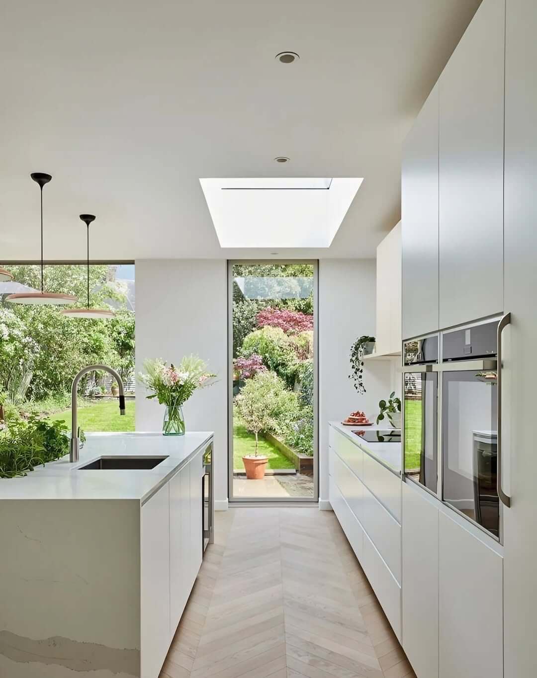 Skylight and Tall Window Frame a Lush Garden View